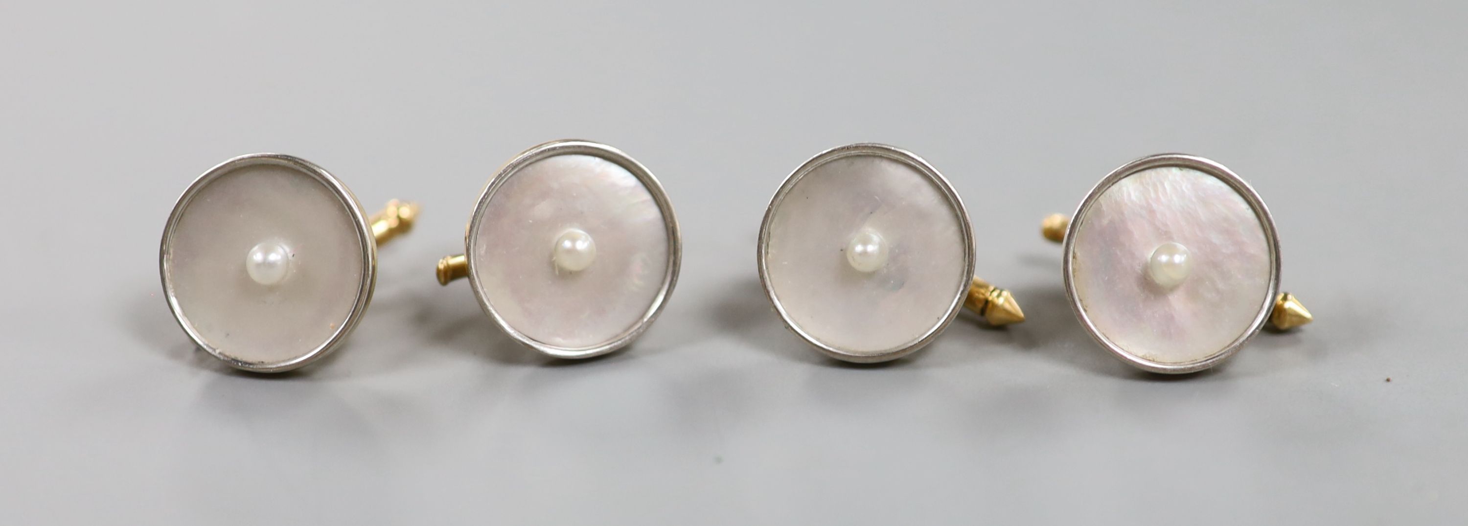 A set of four yellow metal (engraved 14), mother of pearl and seed pearl set dress studs